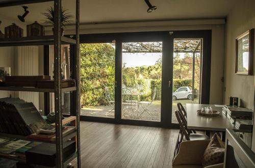 a living room with a table and a sliding glass door at Bed & Breakfast San Lazzaro Room in San Lazzaro di Savena