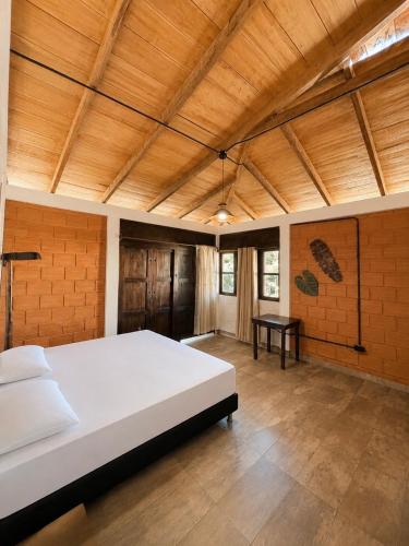 a large bedroom with a large white bed in a room at La Cabaña Mr Brown in Puerto Leguízamo