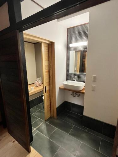 a bathroom with a sink and a mirror at NouHarborVilla in Itoigawa