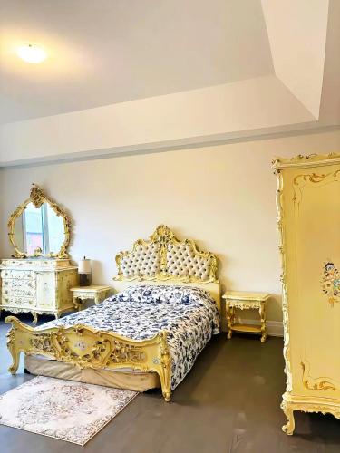 a bedroom with a gold bed and two tables at NEW Spacious BR with Ensuite Bathroom in Innisfil