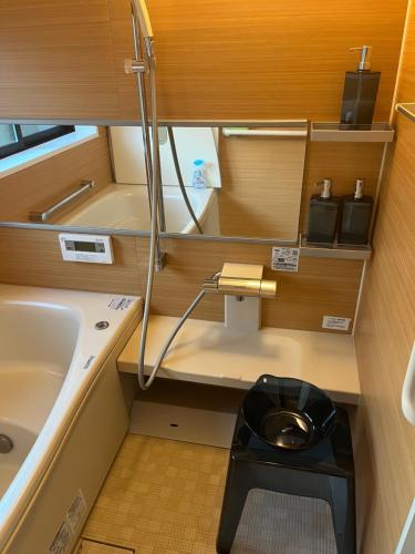 a small bathroom with a toilet and a sink at 悠の宿 in Katsuyama