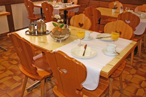 a wooden table with a white table cloth on it at Hotel Glärnisch Hof in Horgen