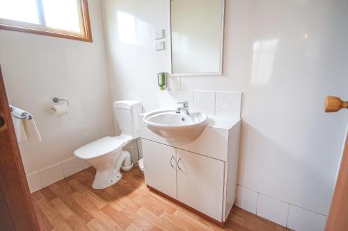 a white bathroom with a sink and a toilet at Horsham Holiday Park in Horsham