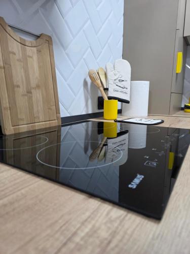 a glass table with utensils on top of it at Ssalamandra home's in Ocna-Mureşului