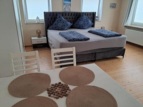 a bedroom with a bed with two tables and two chairs at MäuseScheune in Sankt Annen