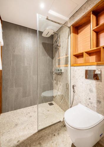 a bathroom with a toilet and a shower at Mixay Boutique Hotel Da Nang in Danang
