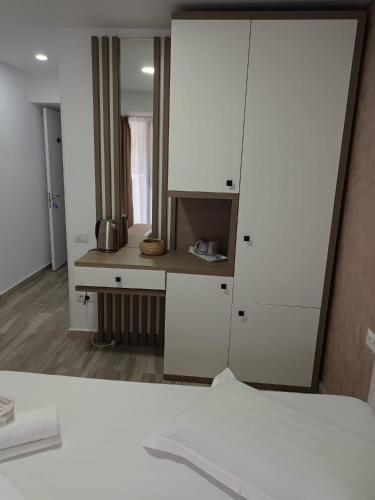 a bedroom with a white cabinet and a bed at Sea View Apartments Olimp by Stela in Olimp