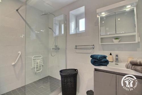 a bathroom with a glass shower and a sink at De la roche in Langourla