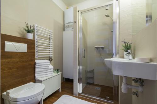 a bathroom with a toilet and a sink and a shower at 7 Koron - Exclusive Apartments in Kraków