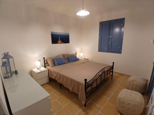 a bedroom with a bed with two lamps on it at Casale Mute Terre in Tuglie