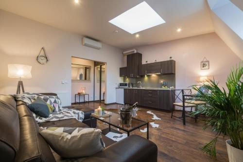 a living room with a couch and a table at 7 Koron - Exclusive Apartments in Kraków