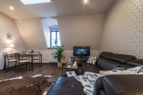 a living room with a couch and a table at 7 Koron - Exclusive Apartments in Kraków