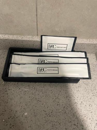 a group of three white books sitting on a counter at DBC Hotel in Semporna