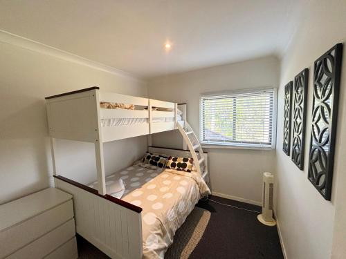 a bedroom with a bunk bed and a bunk bed at Arcos in Hat Head