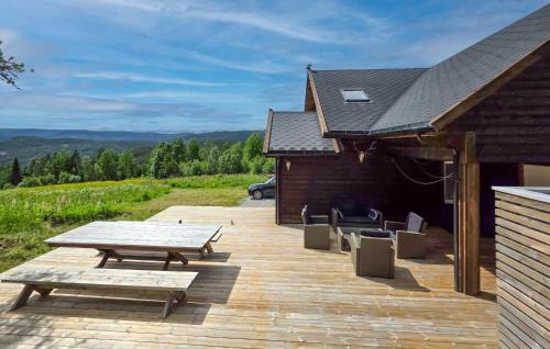 a wooden deck with a picnic table and a building at Stunning Home In Treungen in Treungen