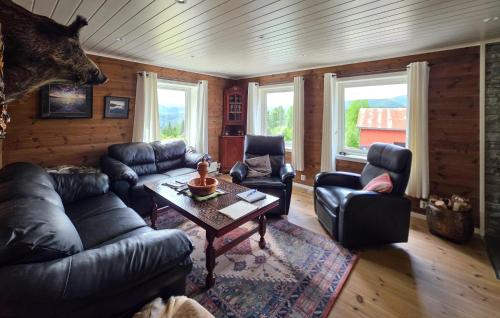 a living room with leather couches and a table at Stunning Home In Treungen in Treungen
