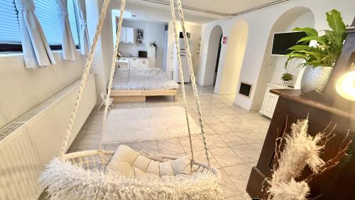 a room with a hanging swing with a bed at Black Forest Hideaway in Gernsbach