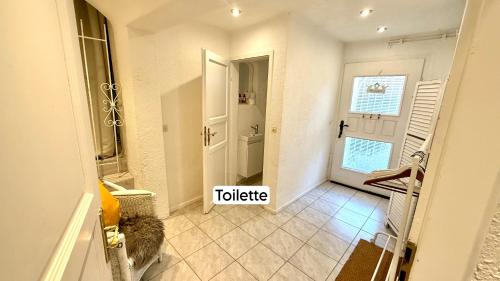 a hallway with a door and a tiled floor at Black Forest Hideaway in Gernsbach