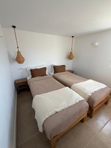 three beds are lined up in a room at Villa Olympia with private pool in Antiparos