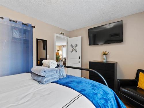 a bedroom with a bed with towels on it at All About Alaska in Anchorage