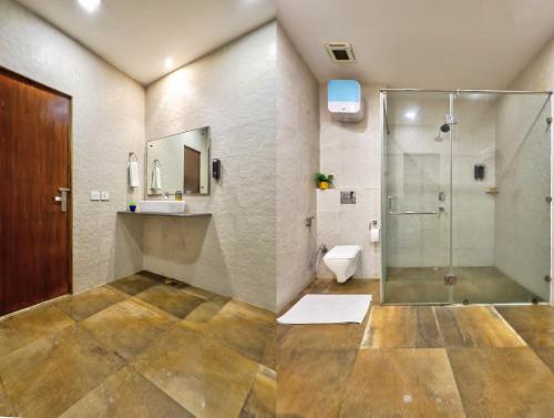 a bathroom with a shower and a toilet at Hotel Royal Imporio Surajkund Faridabad in Faridabad