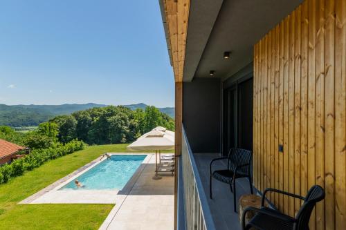 a view from the balcony of a house with a swimming pool at Blacksmith house - SPA, Heated outdoor pool, Kids zone in Varaždinske Toplice