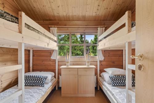 two bunk beds in a room with a window at Peaceful Holiday Home Close To Nature in Glesborg