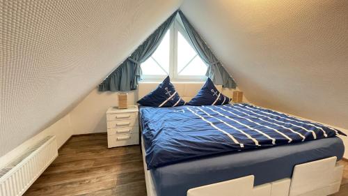a bedroom with a bed and a window at Strandbox & Strandresidenz in Norderney