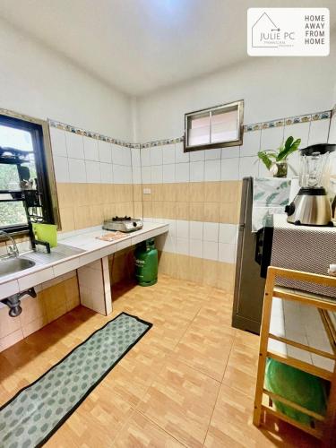 a small kitchen with a counter and a sink at Temple House by Julie PC in Ko Phangan