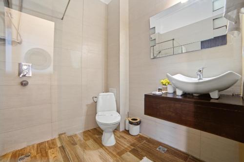 a bathroom with a white toilet and a sink at InWaves in Vama Veche
