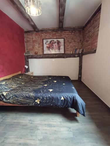 a bedroom with a bed and a brick wall at Gościniec Villa Romana in Piecki