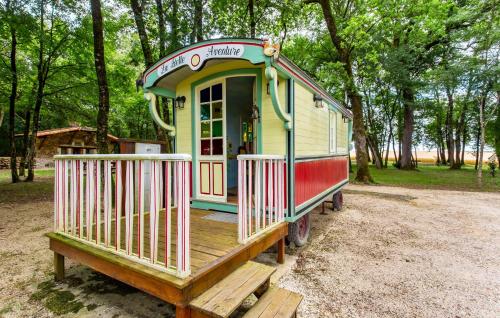 a small house is sitting on a wooden deck at Amazing Home In Lonnes With Heated Swimming Pool in Lonnes