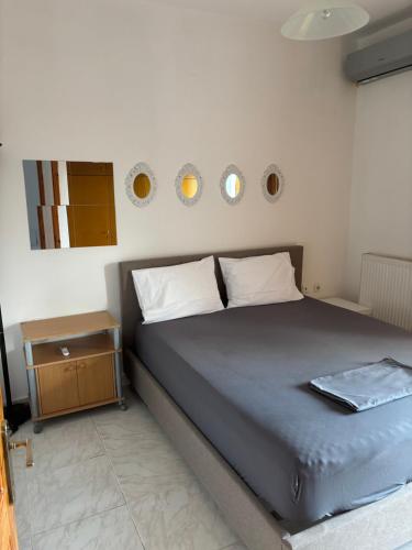 a bedroom with a bed and a side table at Dimitra House Entire apartment with balcony and view in Pherrai