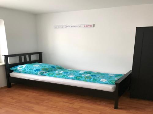 a bedroom with a bed with a blue comforter at Apartment Am Ring in Bochum