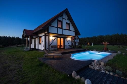 a house with a pool in front of it at Klinwdzydze in Wdzydze Tucholskie