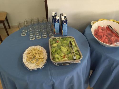 a table with a blue table cloth with a tray of food at Oriental Nights Rest House in Al Wāşil