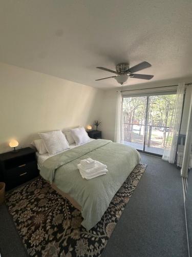 a bedroom with a bed and a ceiling fan at Cozy Alpine A-Frame in Flagstaff