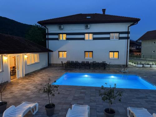 a villa with a swimming pool at night at Althea Home & Wellness in Bihać