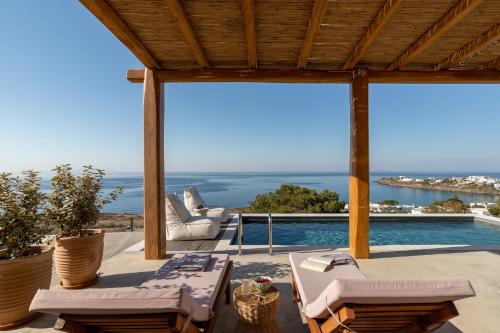a patio with a view of the ocean from a house at Villa Lefko in Ano Syros