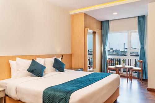 a hotel room with a large bed and a window at Marlo Hotels in Kathmandu