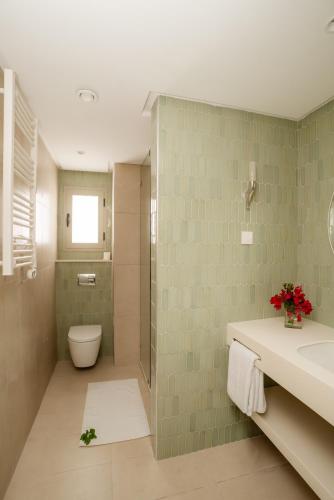 a bathroom with a toilet and a sink at Seabel Alhambra Beach Golf & Spa in Port El Kantaoui