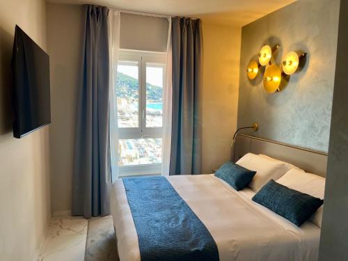 a bedroom with a bed with a large window at Boutique Hotel Alassio in Alassio