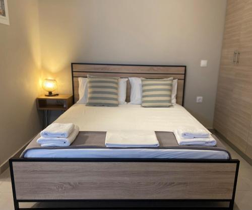a bedroom with a bed with towels on it at Regium Studio in Nikiana
