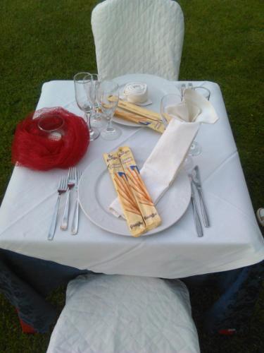 a white table with a plate of food on it at Agriturismo La Maddalena in Acate