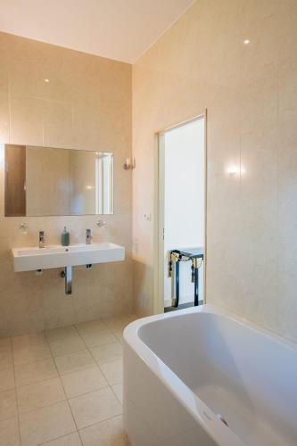 a large bathroom with a tub and a sink at Château de La Sizeranne - Beausemblant in Beausemblant