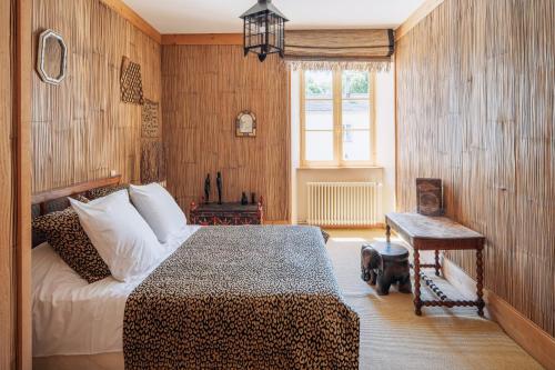 a bedroom with a leopard print bed and a window at Château de La Sizeranne - Beausemblant in Beausemblant