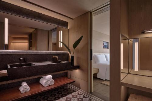 a bathroom with a sink and a mirror at Alila Shanghai in Shanghai