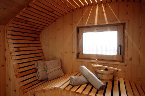 a sauna with two chairs and a window at Chalet Tschogerhof Tiers am Rosengarten Dolomiten in Tires