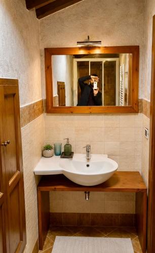 a person taking a picture of a sink in a bathroom at Il Borghetto di Pedana- in Città di Castello