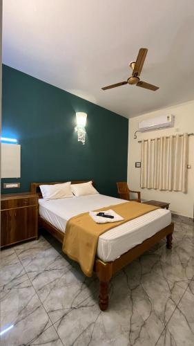 a bedroom with a bed and a ceiling fan at Gravity Groups Core - Sivadurai Residency in Puducherry Airpoert